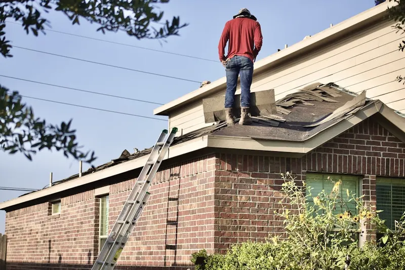 Professional roofer working on a residential roof in Panorama